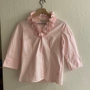3/4 sleeve pink shirt with ruffle collar.